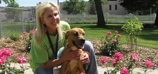 Lady with a dog by some roses